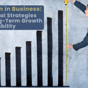 A bar graph on a wall with a business women holding a tape measure to the highest bar with the title in the left corner